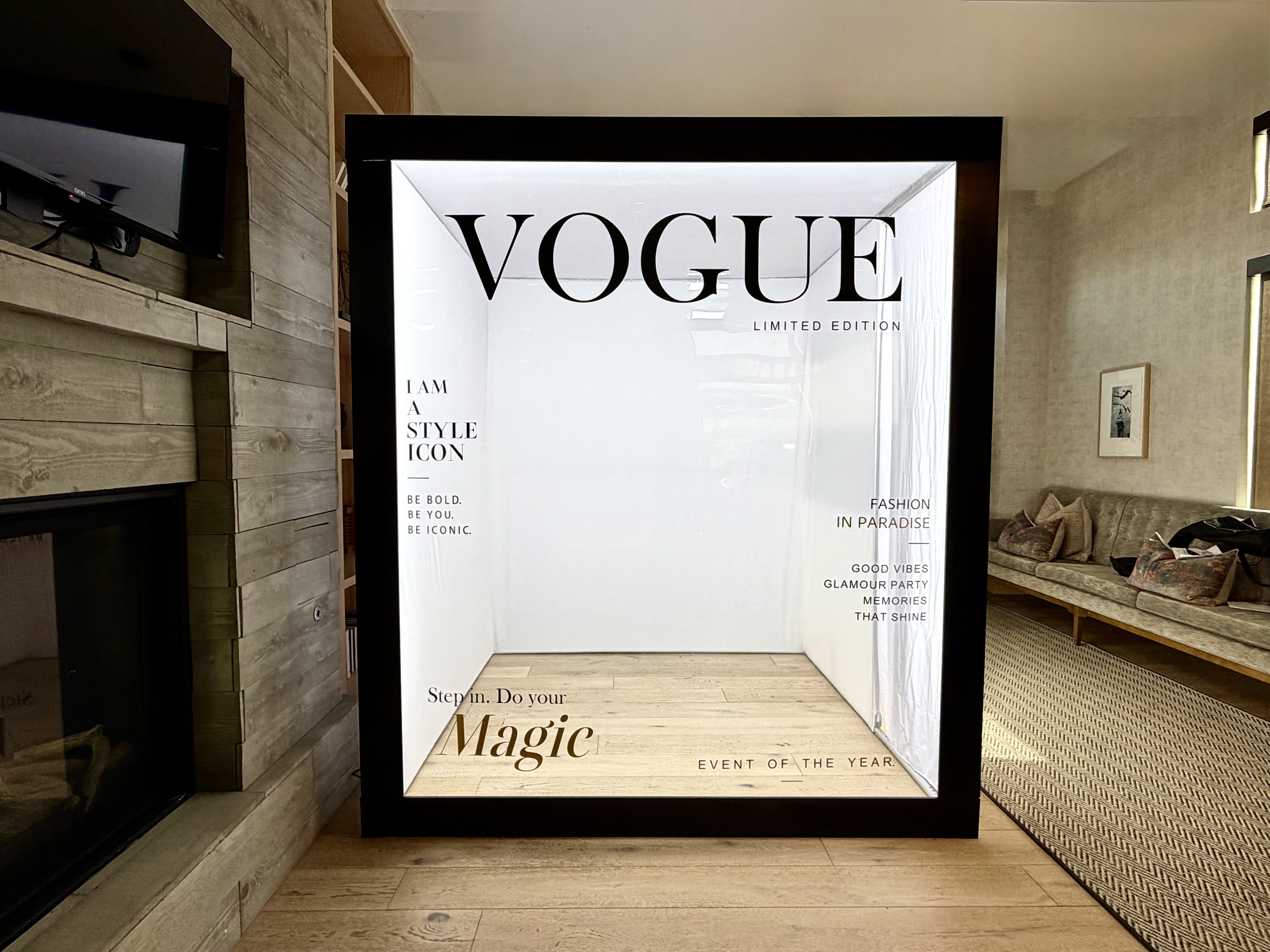 Walk-in magazine cover photo booth in Denver Colorado with oversized magazine frame, styled seating and glam props